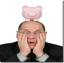 Business Man with Piggy Bank on head and hands on face